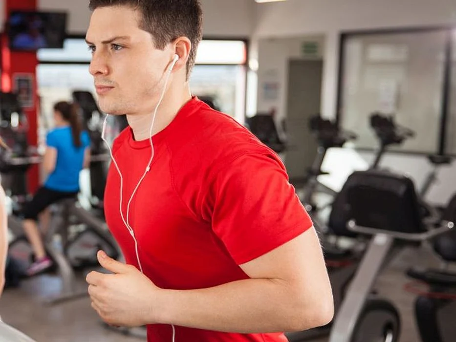 man on treadmill listening to music
