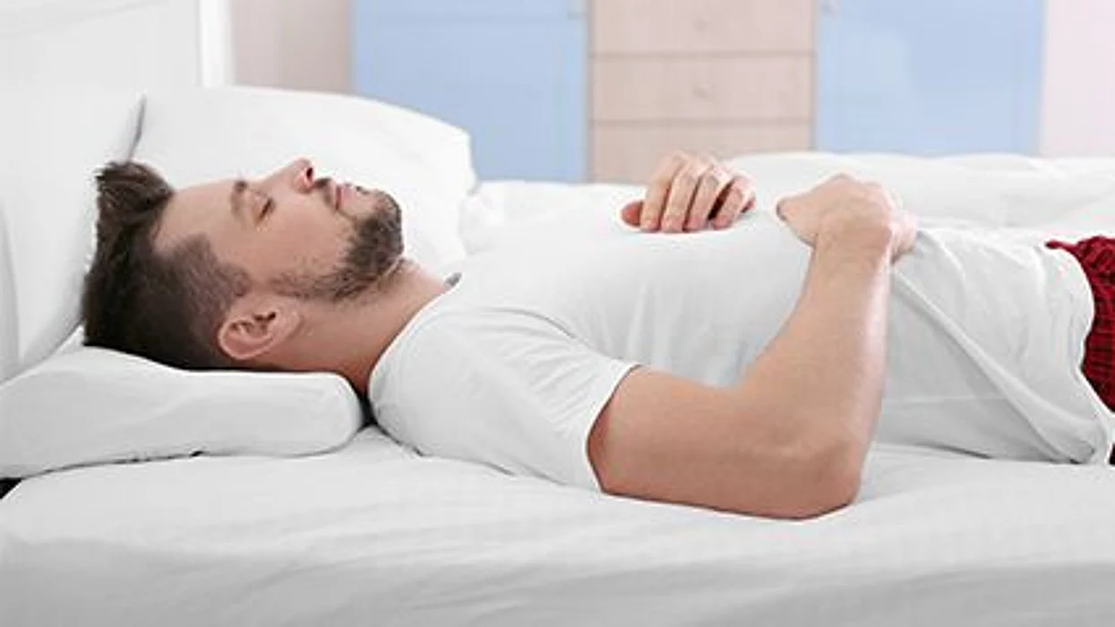 a man in a bed asleep