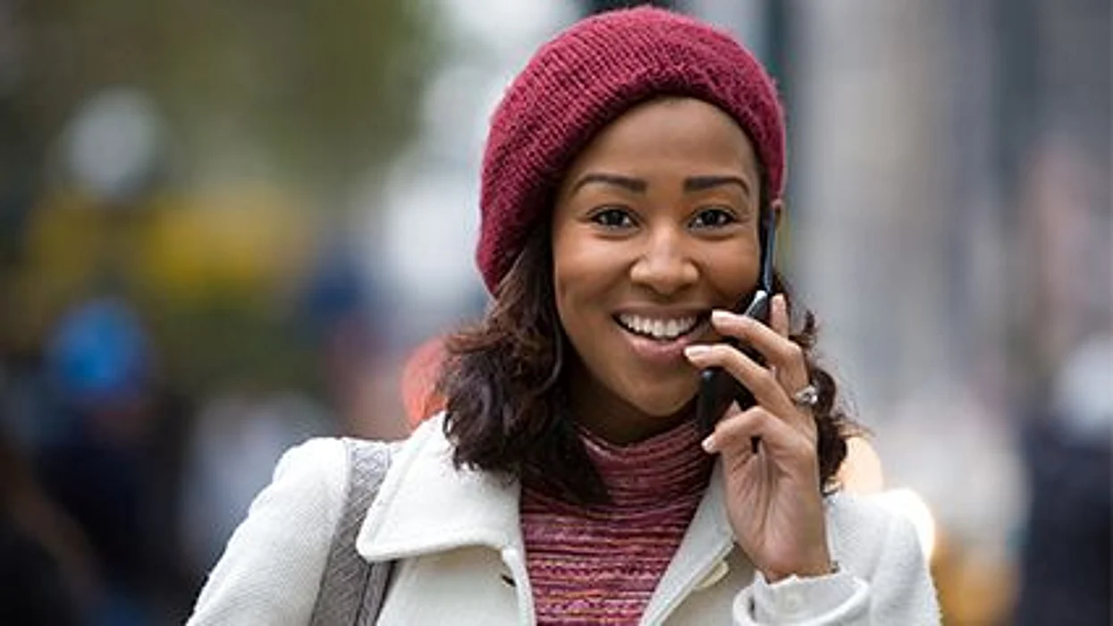 a woman walking and talking on the phone