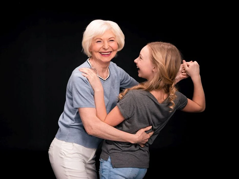 Grandmother and granddaughter dancing