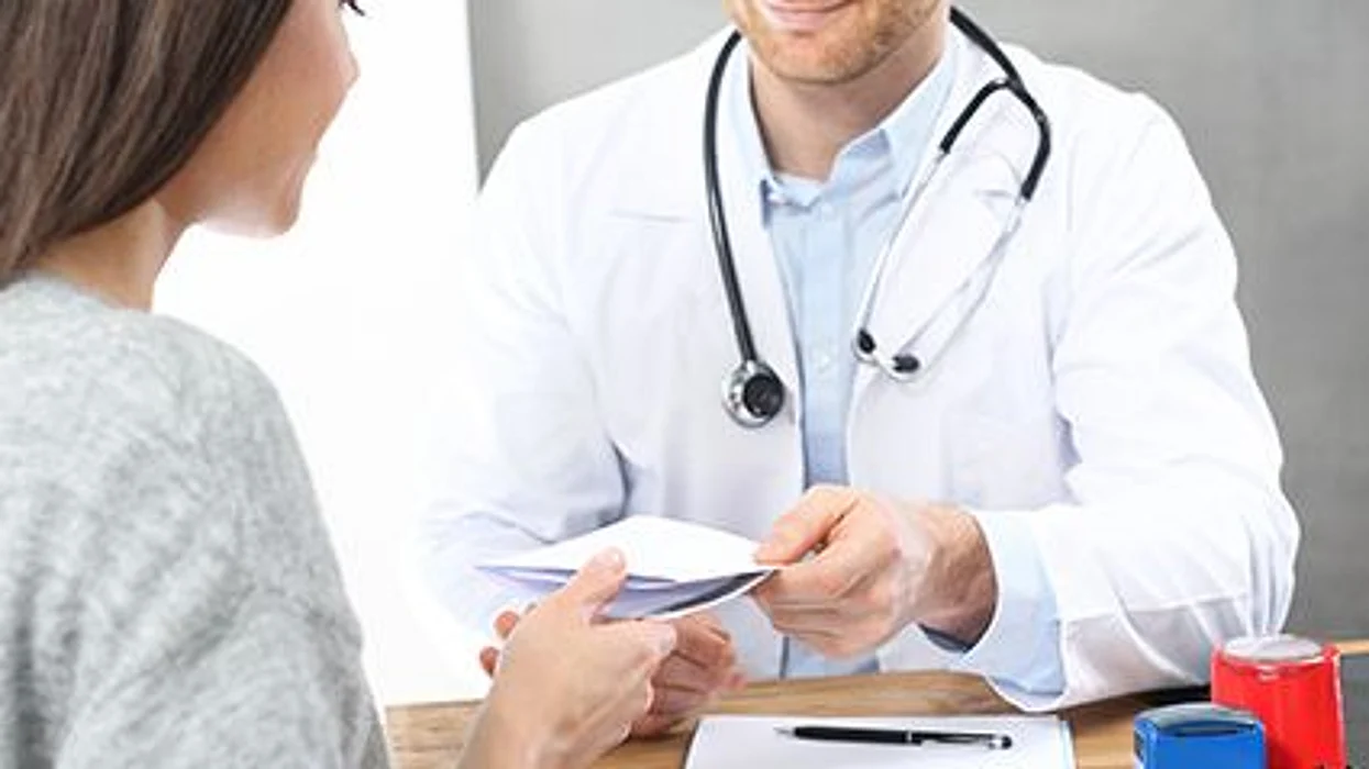 a woman during doctor\'s office consultation