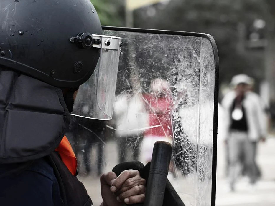 Police and shields during a riot