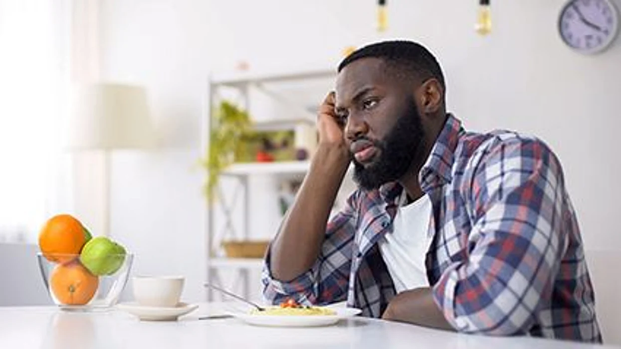 a man sitting at the table and worring