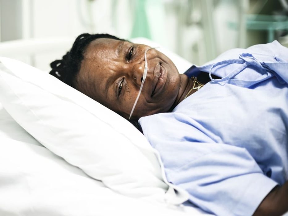 sick patient in hospital bed