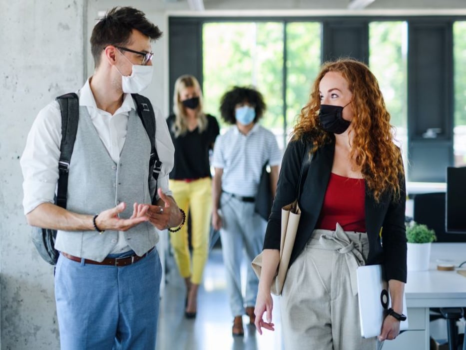 Workers returning to office wearing masks