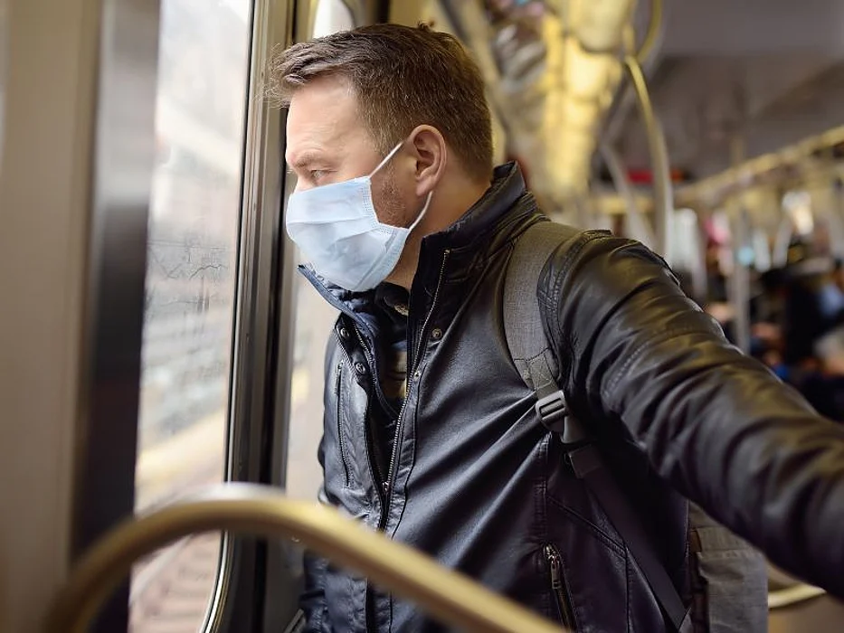 man on train wearing mask