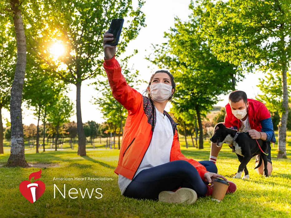 couple in the park wearing masks