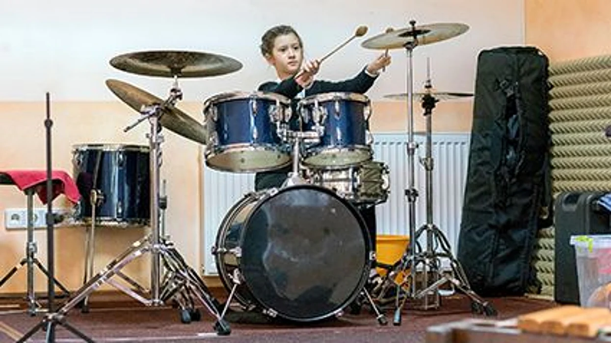 a girl behind drums