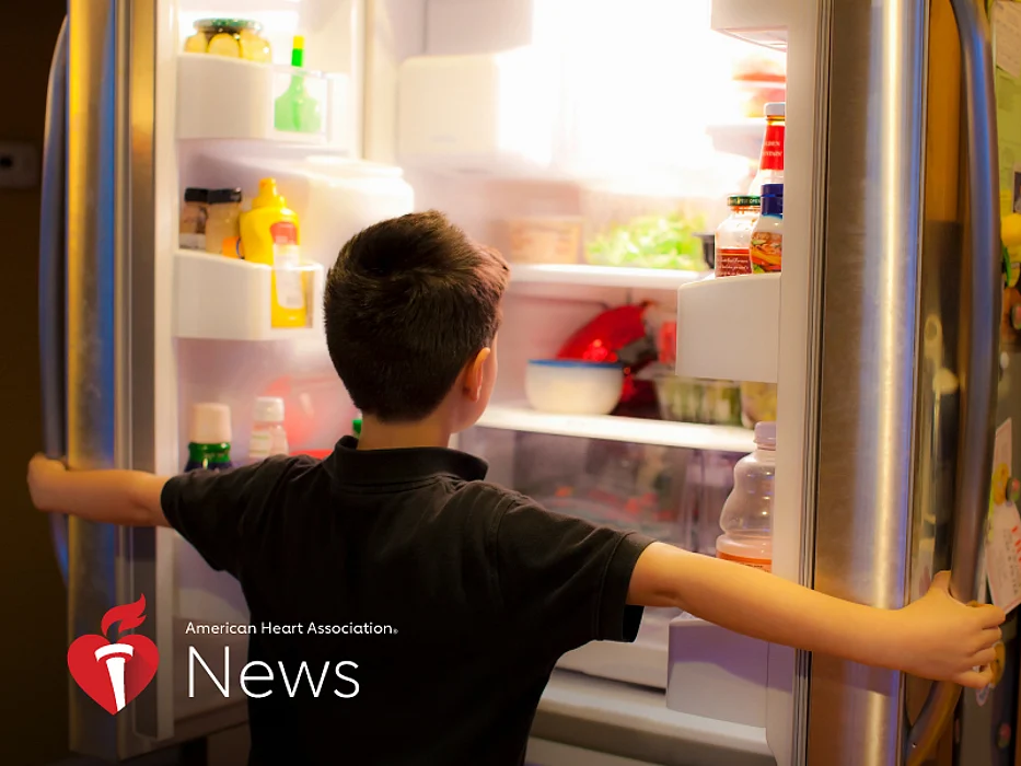 a boy looking at the fridge