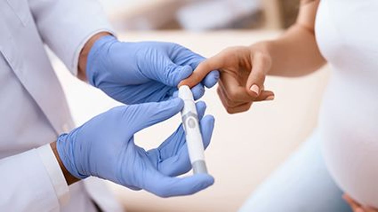 a person testing blood sugar