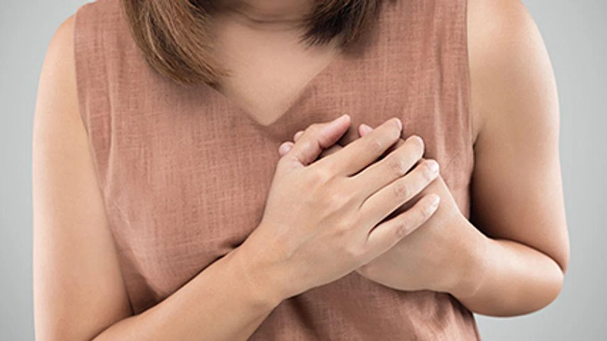 woman holding her heart