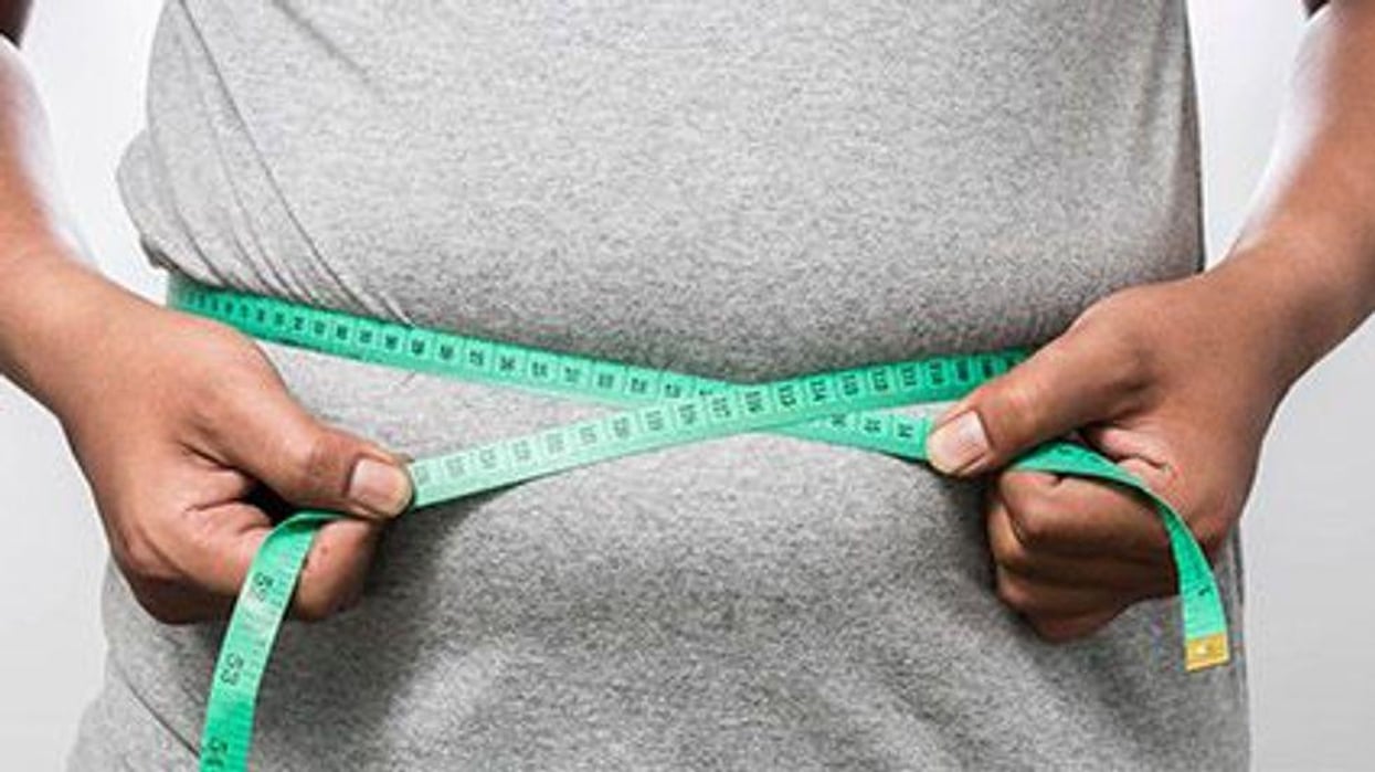 a person measuring his waist