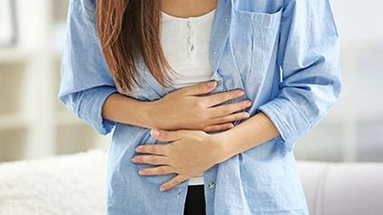 a woman holding her stomach