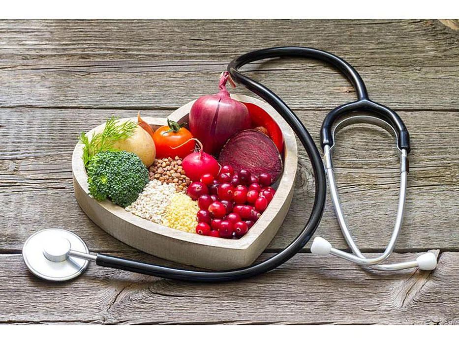 vegetables and beans on a tray in the shape of heart