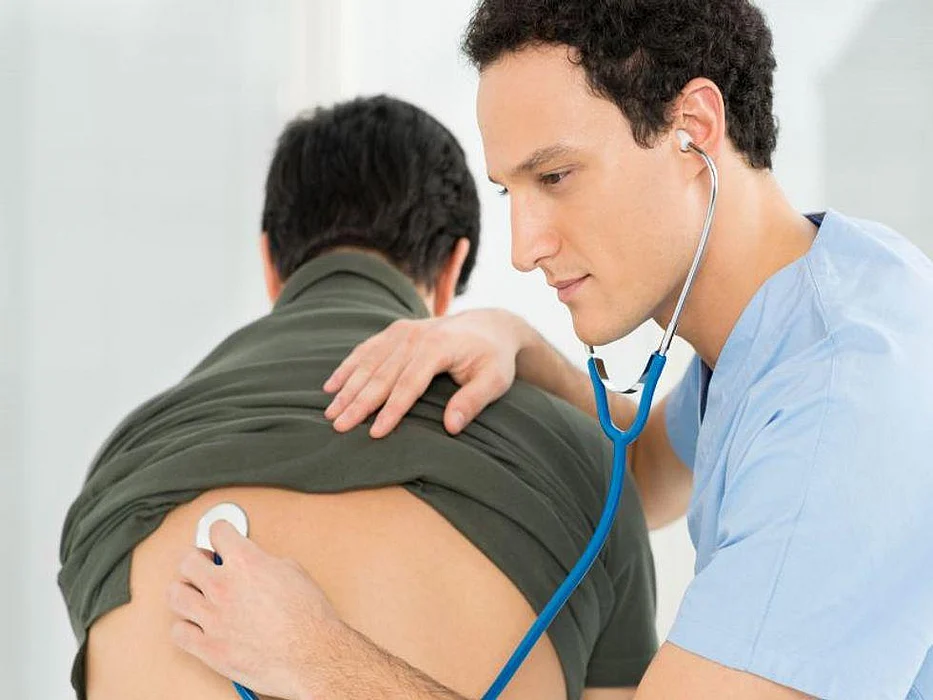 doctor listening to lungs