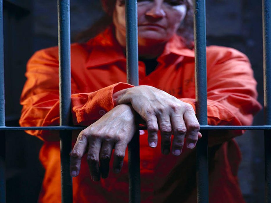 woman behind a prison bars