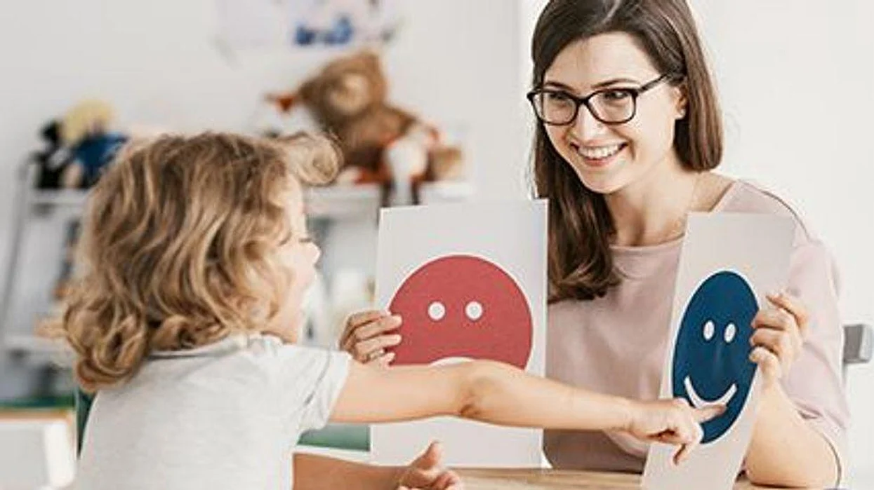 a woman teaching a child