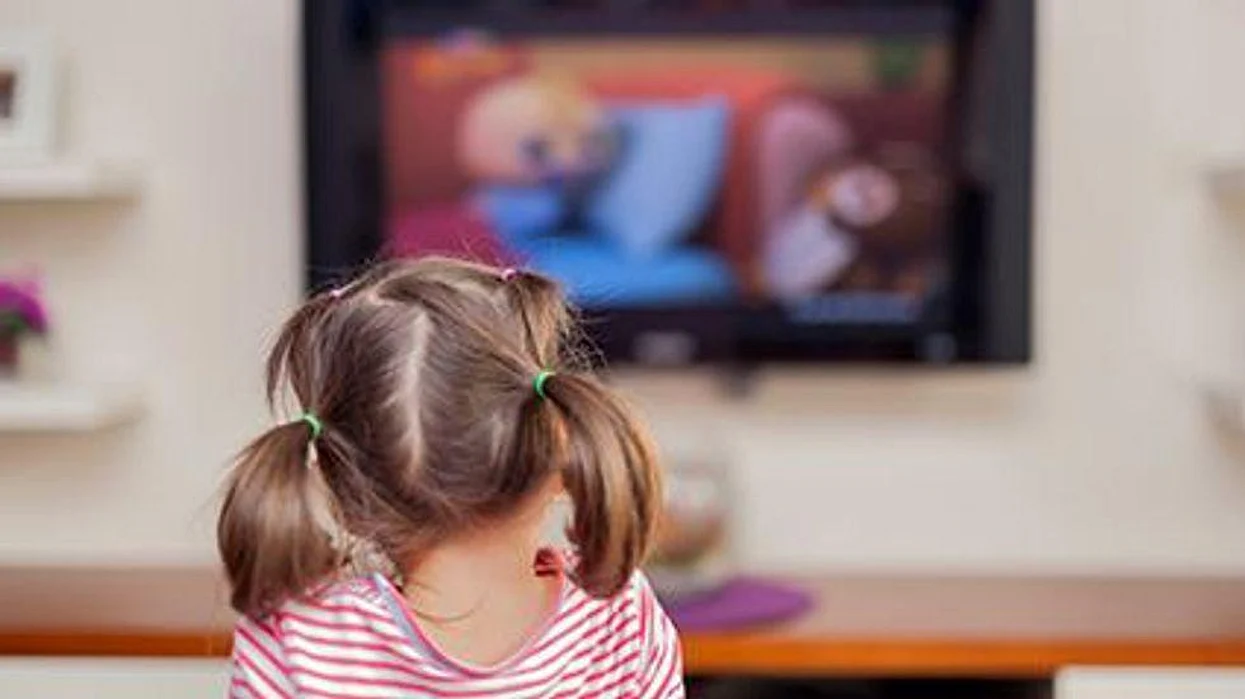 a girl in front of tv