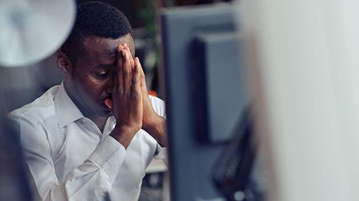 a man stressed in front of the computer