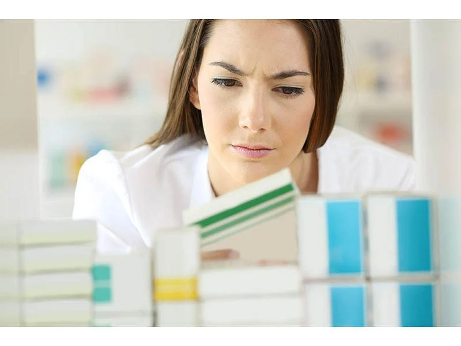 pharmacist looking at drug label