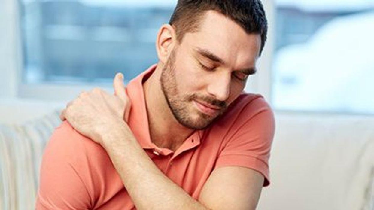 a man holding his shoulder in pain