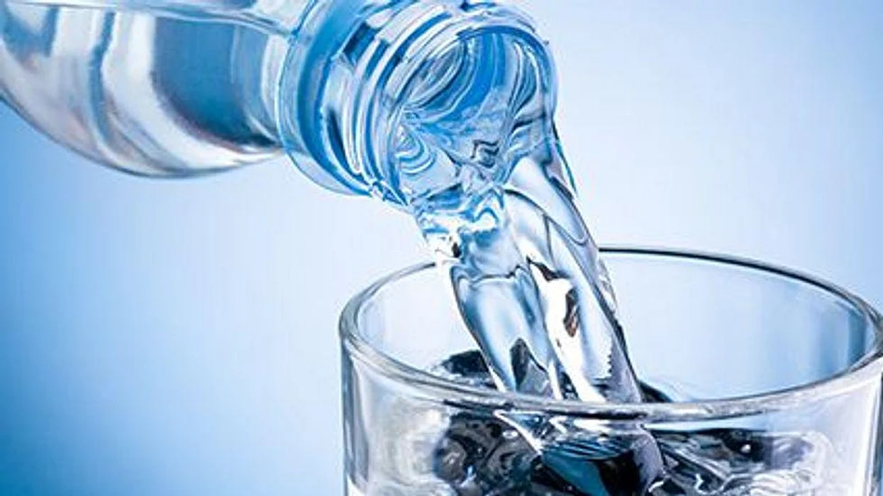 drinking water in a plastic bottle