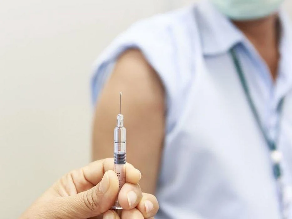person with mask getting a vaccine
