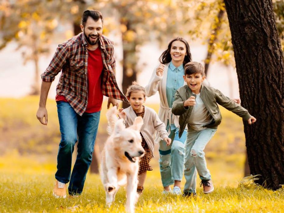 family running after dog