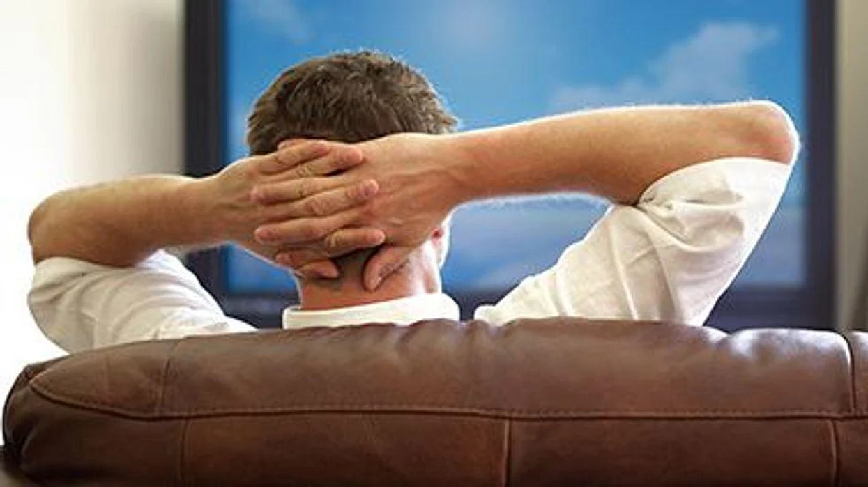 a man sitting in front of the TV