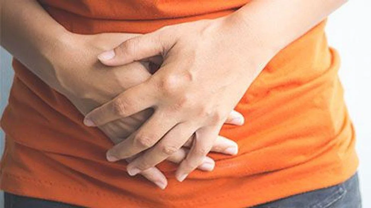 woman holding her stomach