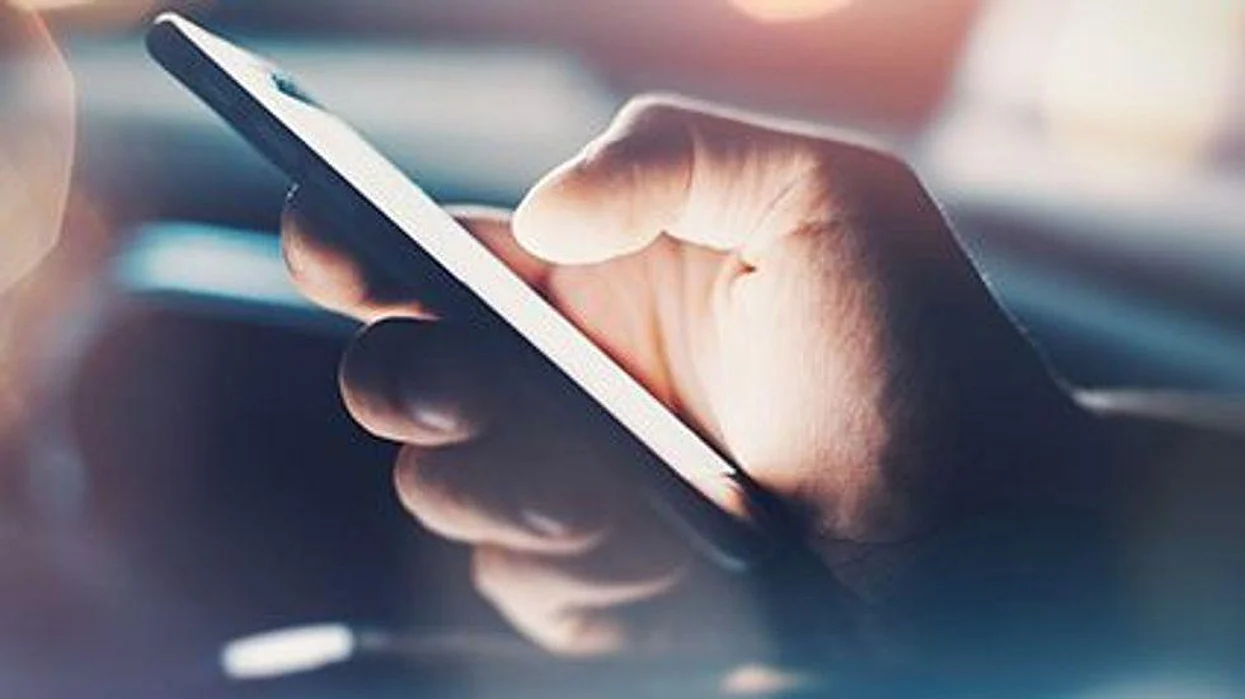 a close up of a hand holding a smartphone