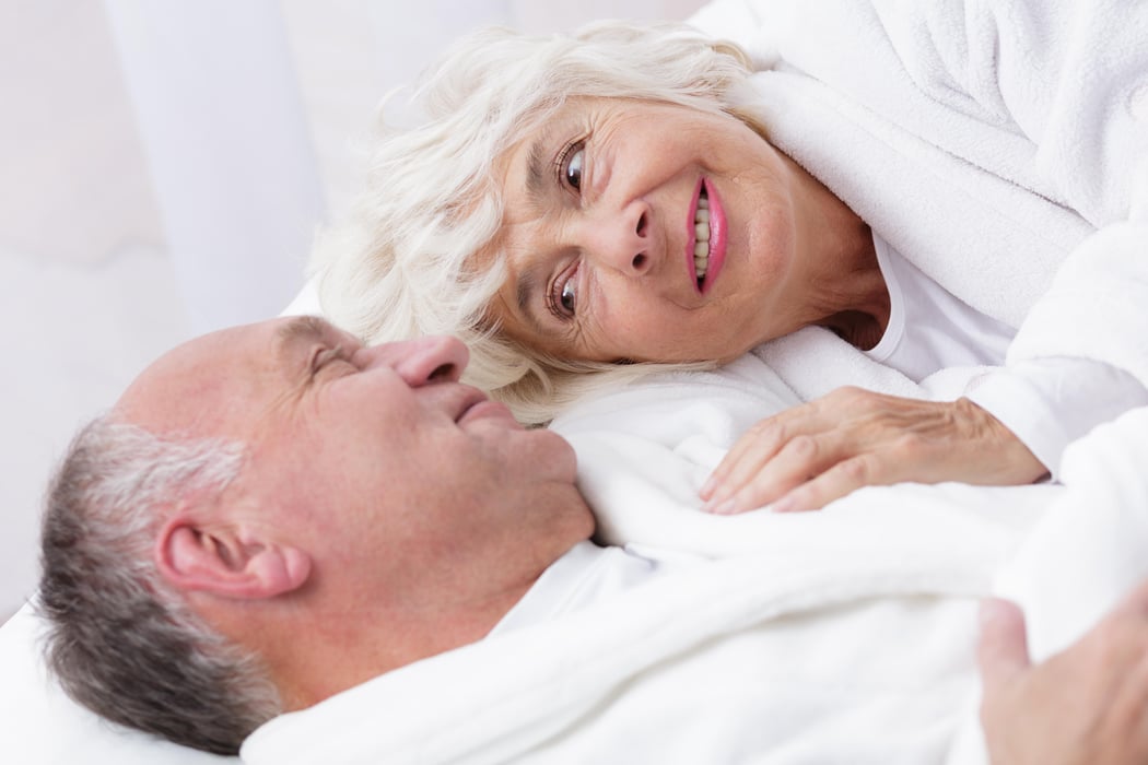Amorous senior couple in bed