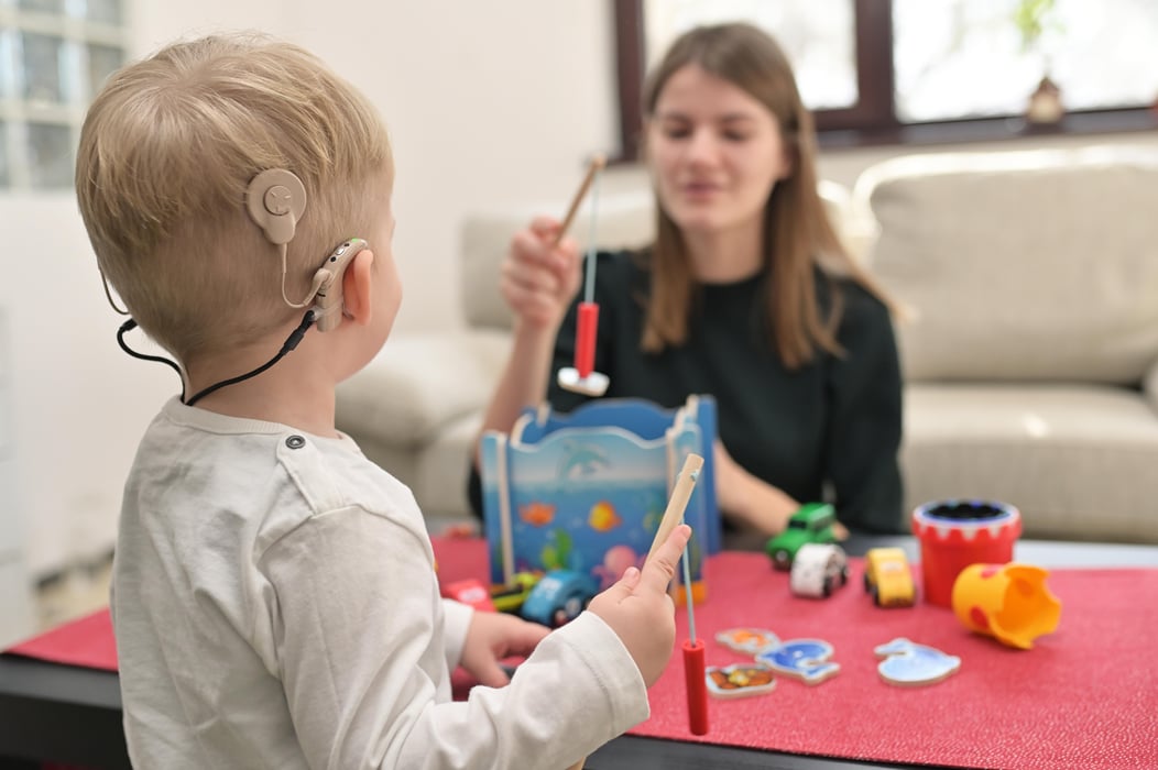 A Boy With Cochlear Implants Playing