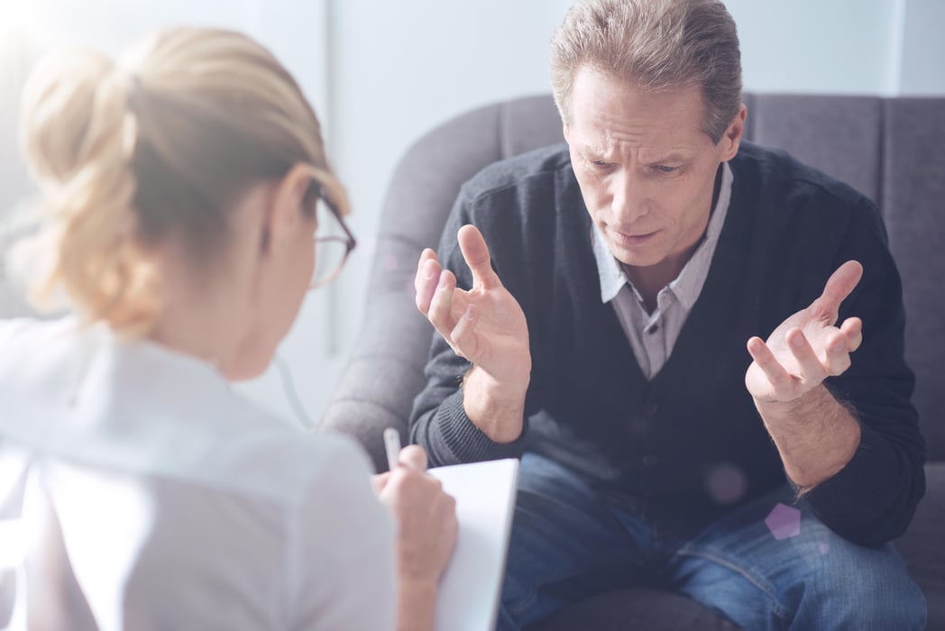 Unhappy depressed man visiting a psychologist depression, anxiety
