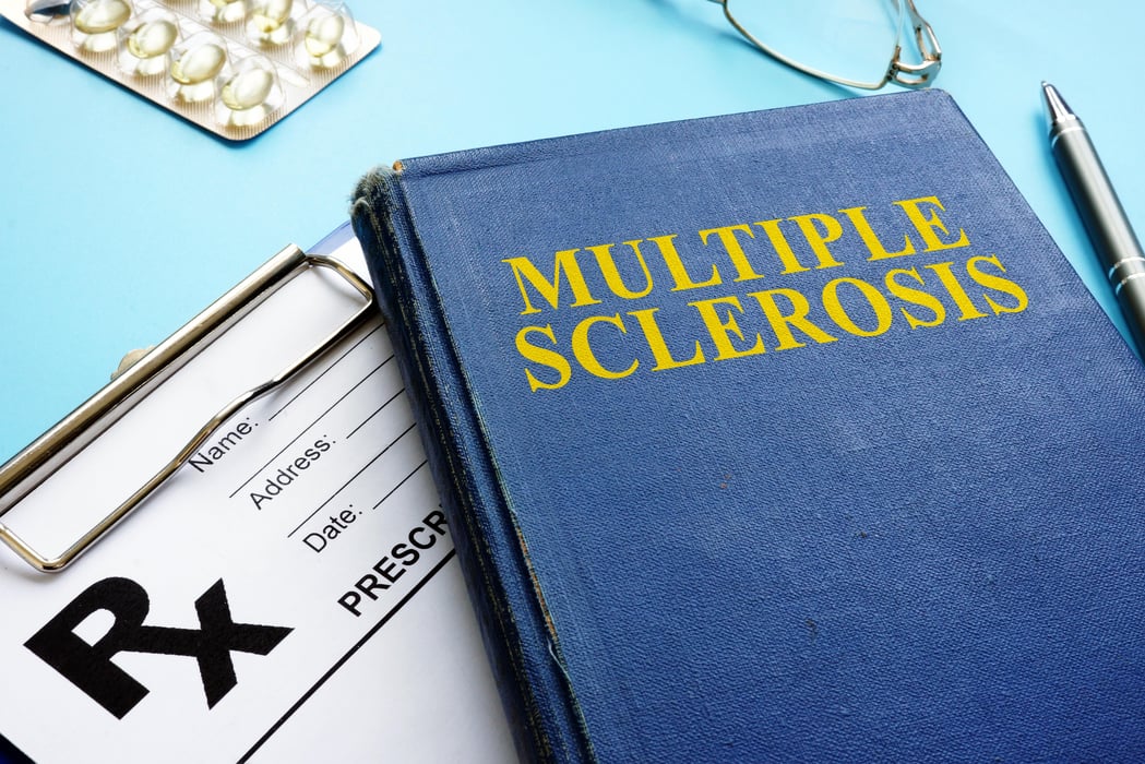 Multiple sclerosis MS book and prescription and pen.