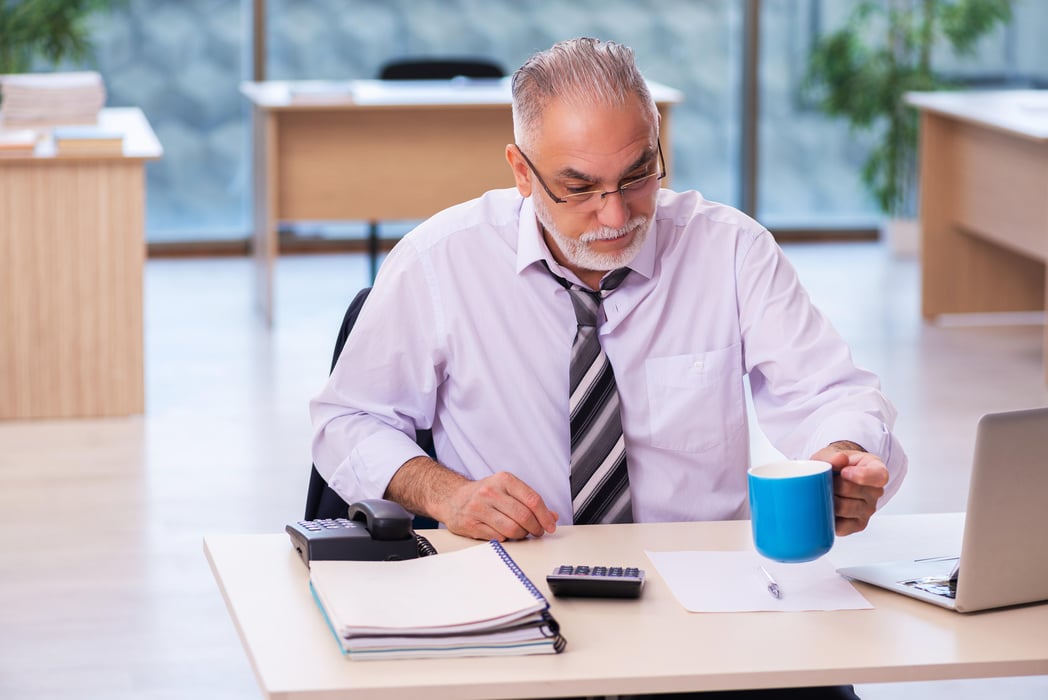 Aged businessman employee unhappy with excessive work