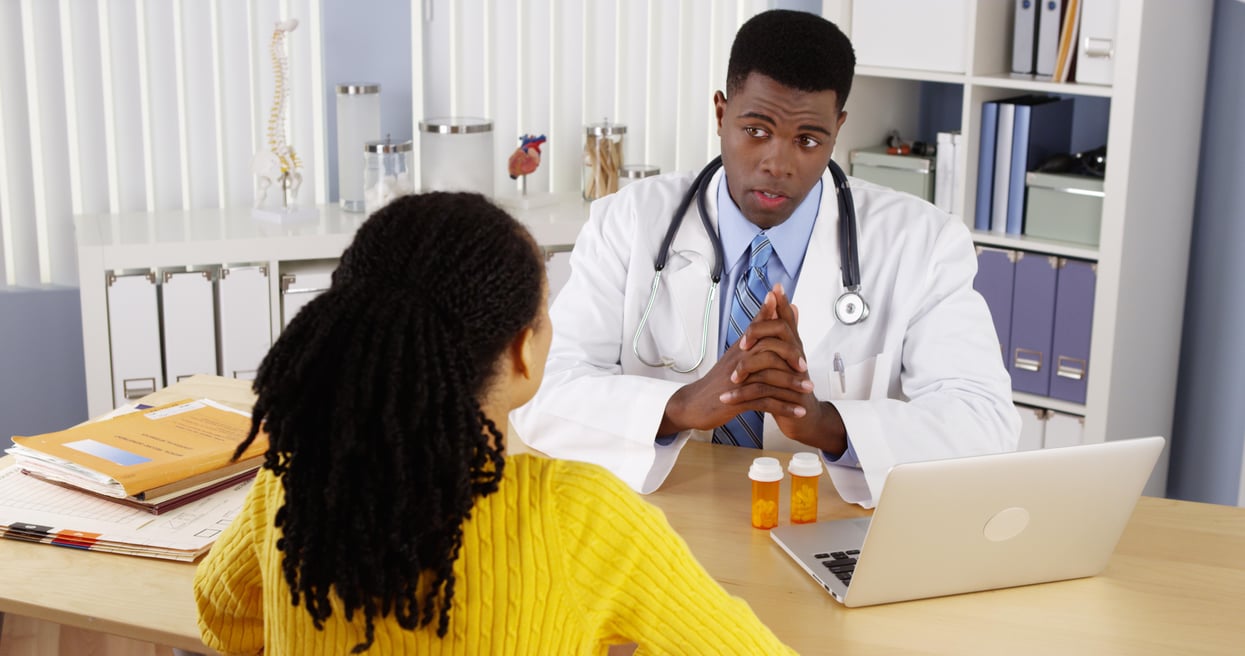 doctor with black patient and prescription meds sickle cell