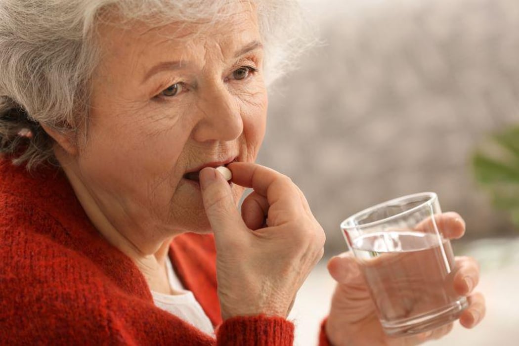 senior geriatric woman pill medication