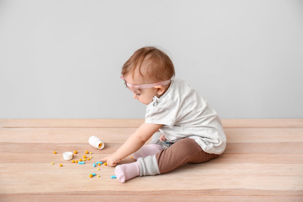 toddler playing with medicines