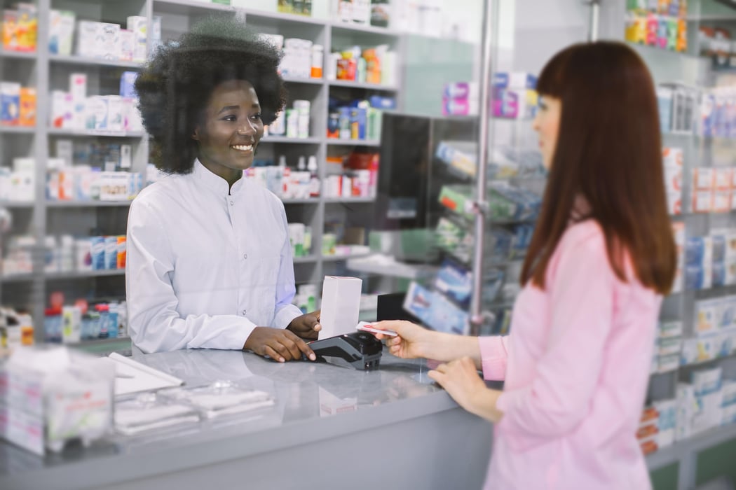 woman getting meds in a pharmacy