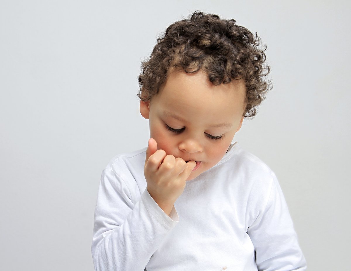 Image of Indian boy child biting his nails-PZ638616-Picxy